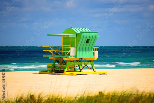 Miami Beach with lifeguard tower and coastline with colorful cloud and blue sky. © Volodymyr