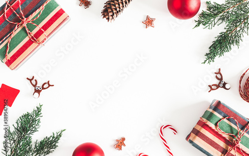 Christmas composition. Christmas gifts, fir tree branches, decorations on white background. Flat lay, top view, copy space