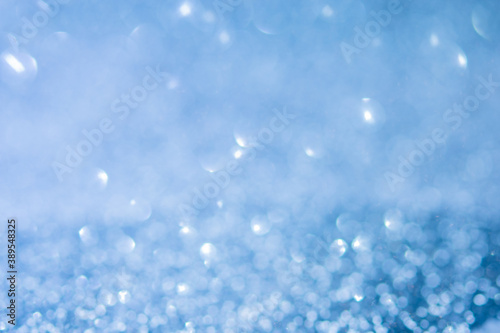 blurred abstract sparkling blue bokeh background. festive decoration for website banner and card concept. soft focus