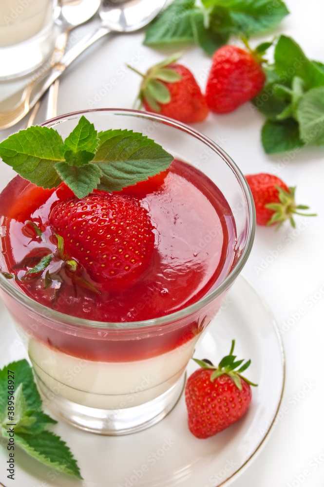 Milk Jelly with strawberry in the glass topped mint leaf Milk Jelly with strawberry in the glass topped mint leaf