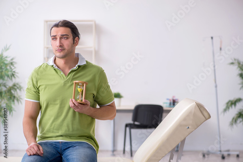 Young man waiting for doctor in the clinic