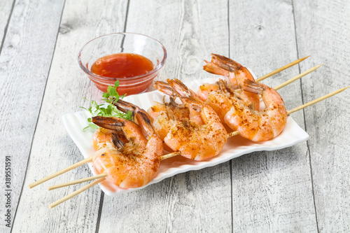 Grilled prawn skewer with sauce