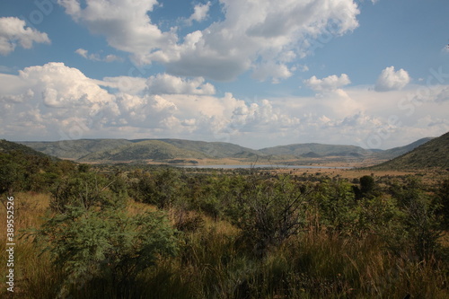 View of Pilanesberg National Park with mountains, grassland, bushland and lake during Spring in South Africa