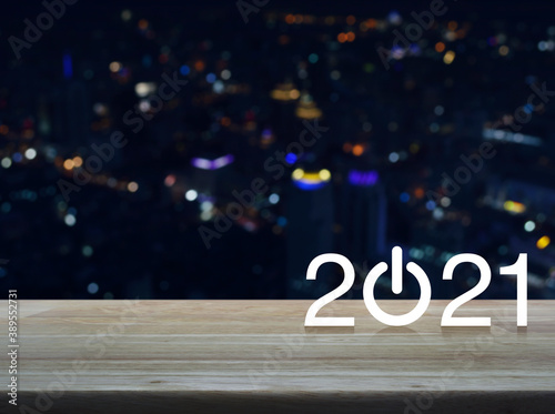 2021 start up business flat icon on wooden table over blur colorful night light modern office city tower and skyscraper, Happy new year 2021 cover concept