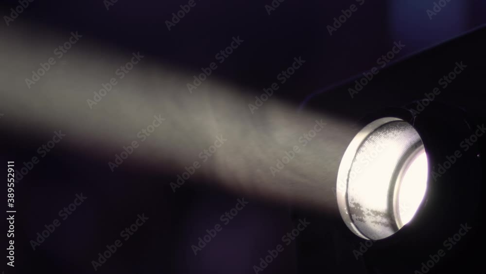 Closeup of small LCD video projector on table in living room, watching movies in home theater