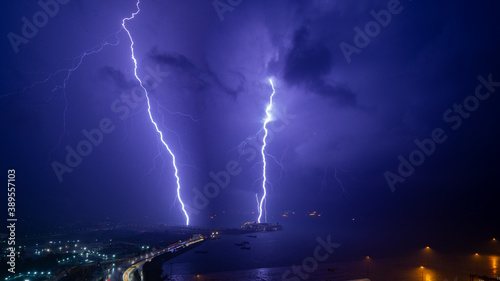 Beautiful lightning bolt hitting the ocean at night.