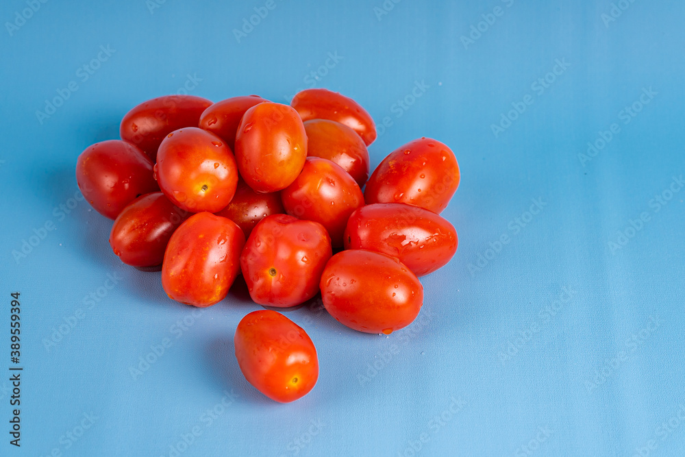 Group of Cherry Tomatoes isolated on blue background Group of Cherry Tomatoes isolated on blue background