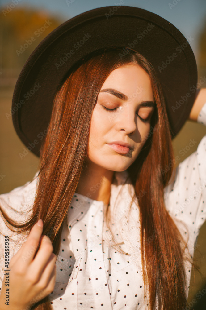 Young beautiful model in a hat with a horse.
Young beautiful model in a hat with a horse.