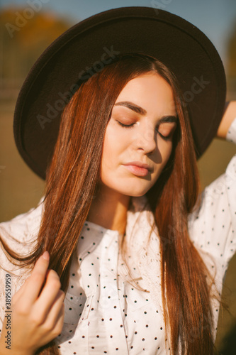 Young beautiful model in a hat with a horse.  © photobyalex