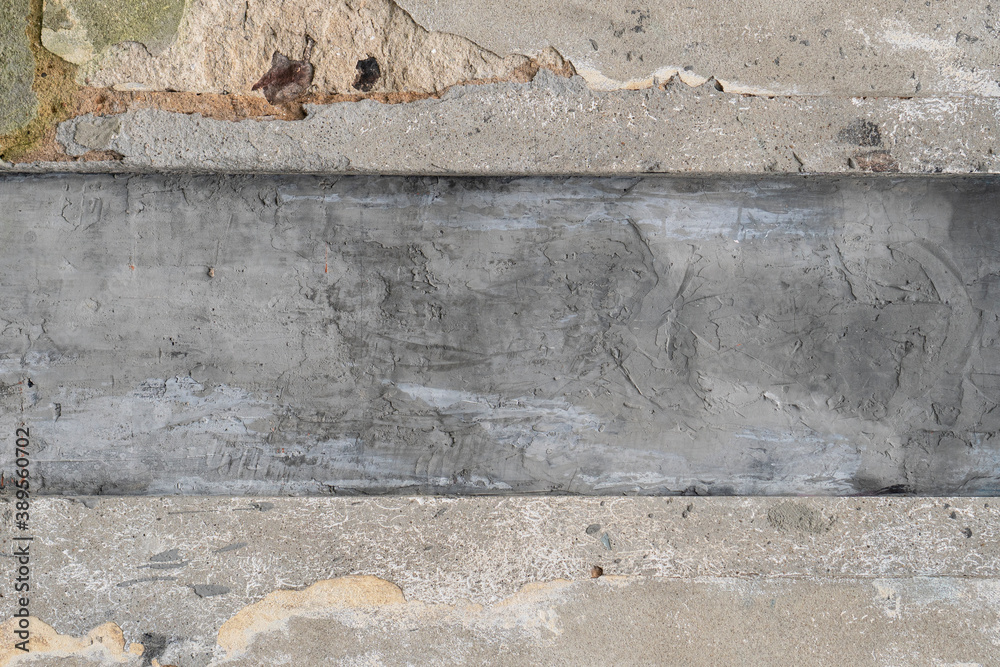 Naklejka premium ement gray streak on a plastered, cracked, weathered wall