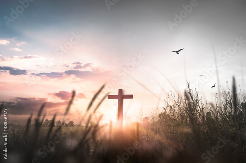 Leinwand Poster Easter concept: Silhouette cross on mountain at sunset background