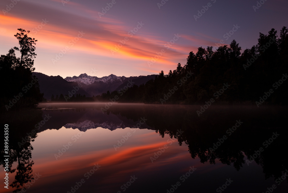 Snow-capped Mount Cook and Mount Tasman reflected in lake Matheson at Sunrise, South Island, New Zealand