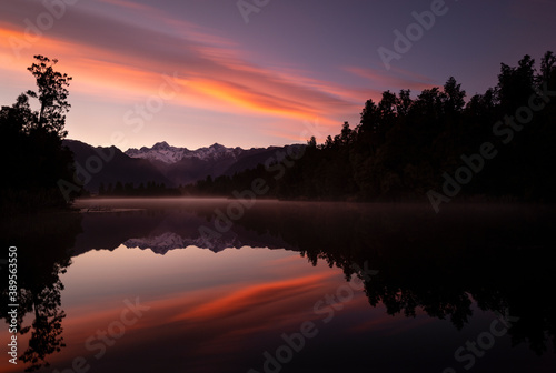 Snow-capped Mount Cook and Mount Tasman reflected in lake Matheson at Sunrise  South Island  New Zealand