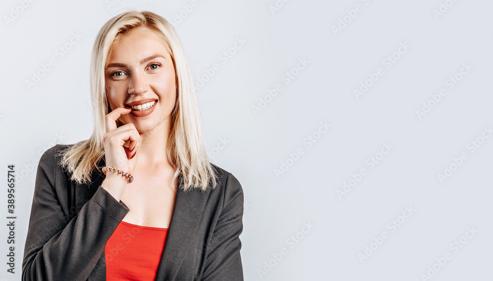 Beautiful happy young girl on gray isolated background Beautiful happy young girl on gray isolated background