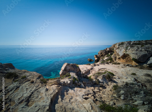 Characteristic tuff stone rocky landscape of the sea coast of Favignana, one of the Egadi islands in Sicily, Italy. Here the Cala Bue Marino one of the most famous beaches