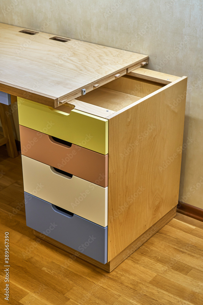 Plywood desk with multi color drawers during assembly Plywood desk with multi color drawers during assembly