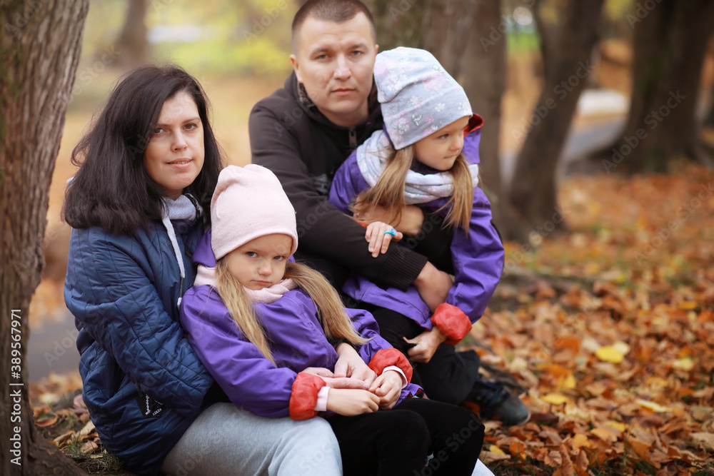 Young family on a walk in the autumn park on a sunny day. Happiness to be together. Young family on a walk in the autumn park on a sunny day. Happiness to be together.