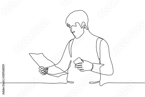 male traveler holds a phone and a map and looks into it, he has a backpack on his shoulders. one line drawing a tourist navigates the terrain