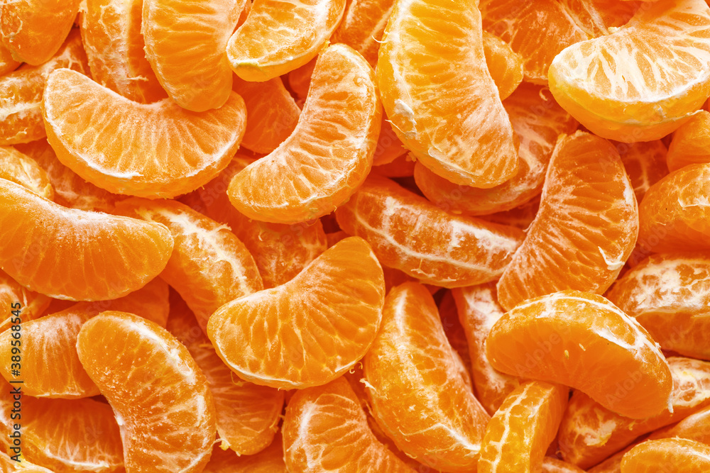Tangerine segments, orange background texture,Flat lay, top view.healthy citrus fruits with lots of vitamins