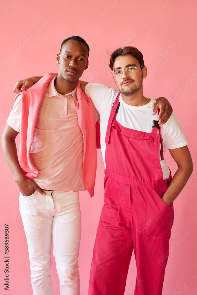 Obraz premium men of different races have close friendship, they hug each other, like a brothers. african and caucasian people