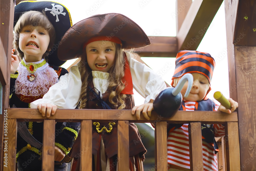 Children's party in a pirate style. Children in pirate costumes are playing  on Halloween. Stock Photo