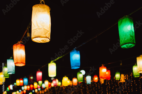 A group of colorful illuminated silk lanterns at night.  Colorful lanterns, Loy Krathong Festival.   © Pornthep