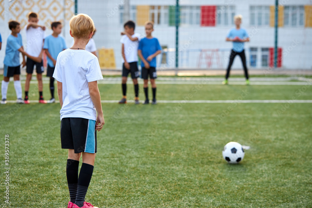 kids boys training with ball before sport competition, they are preparing for match in stadium, 8-9 years old children in unifrom