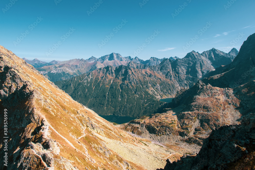 Mountain peak Miedziane in High Tatra Mountains, Poland in autumn, with copper color grass, seen from Szpiglasowy Wierch Mount with Morskie Oko (Eye of the Sea) and Czarny Staw Lakes.