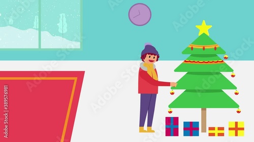 Happy young woman orating a Christmas tree at home photo