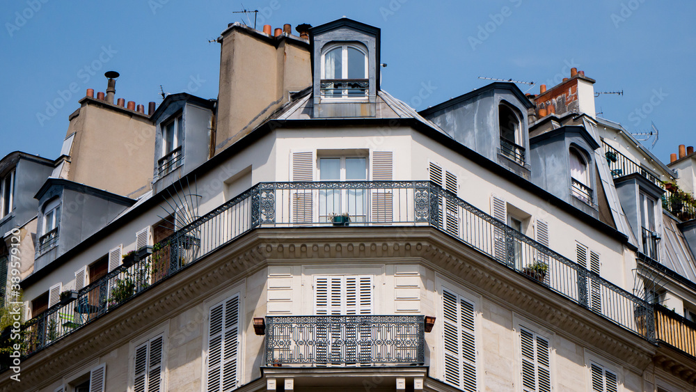 Typical front building in Paris, Blue sky and white clouds, roof and attic room, low-angle shot, haussmann facade, front buildings perspective, historic center, artistic view of the city, symmetry 