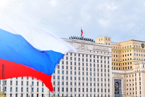 russian flag waving against ministry of defense headquarters in moscow city russia background. Moscow city stalin era architecture. Russian government building. Moscow landmark. Urban landscape