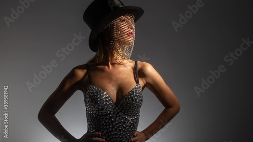 Young woman wearing top hat with sparkly veil and bustier photo