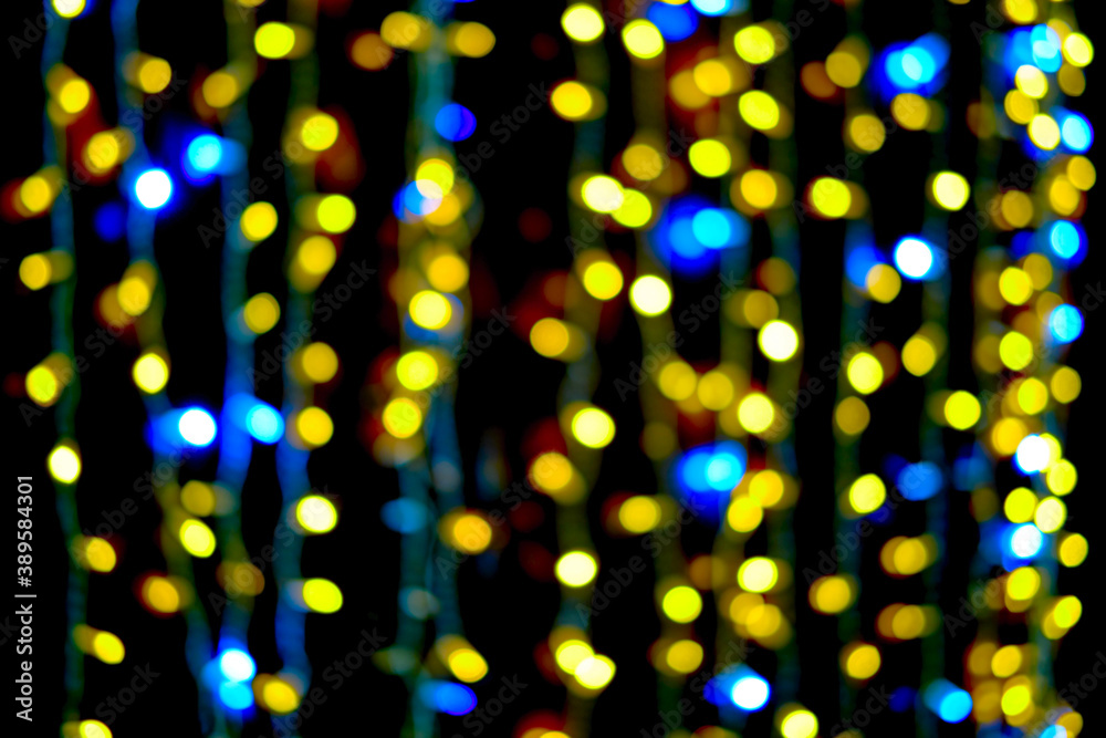 Blurred Christmas background of blue and yellow bokeh lights and lanterns, new year