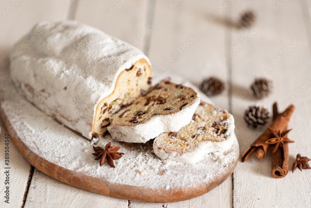 Christmas stollen on wooden background. Traditional Christmas festive pastry dessert. Stollen for Christmas. Christmas stollen on wooden background. Traditional Christmas festive pastry dessert. Stollen for Christmas.