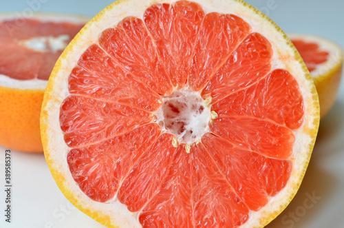Fresh cut grapefruit fruit on white background