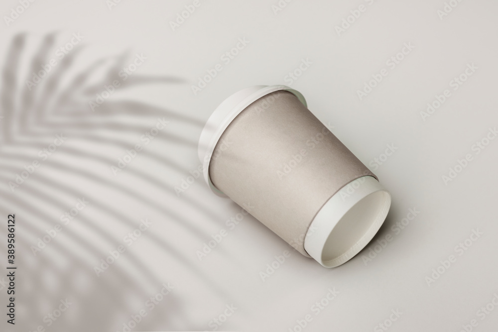 Gray paper cup with palm leaf shadow Gray paper cup with palm leaf shadow