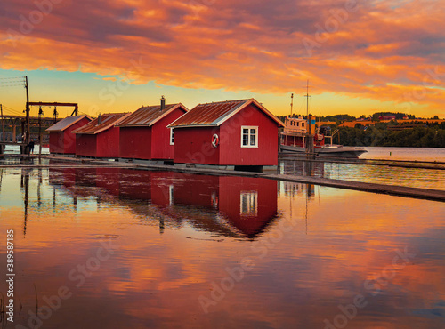 Idyllic small red floating cottages. Location: Fetsund, Norway