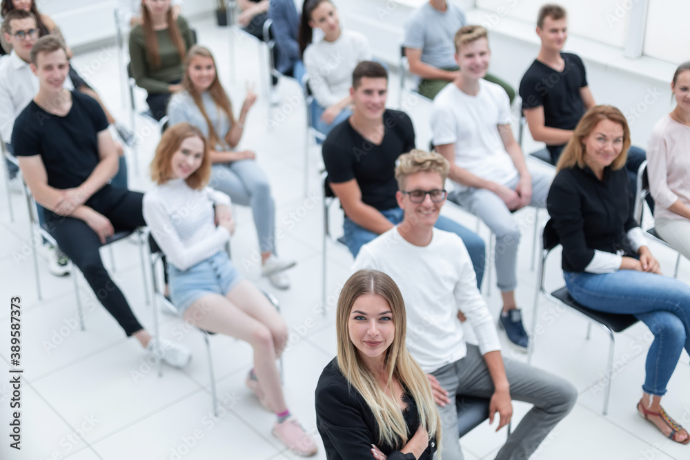 © ASDF - top view. audience of young people sitting in the conference room.