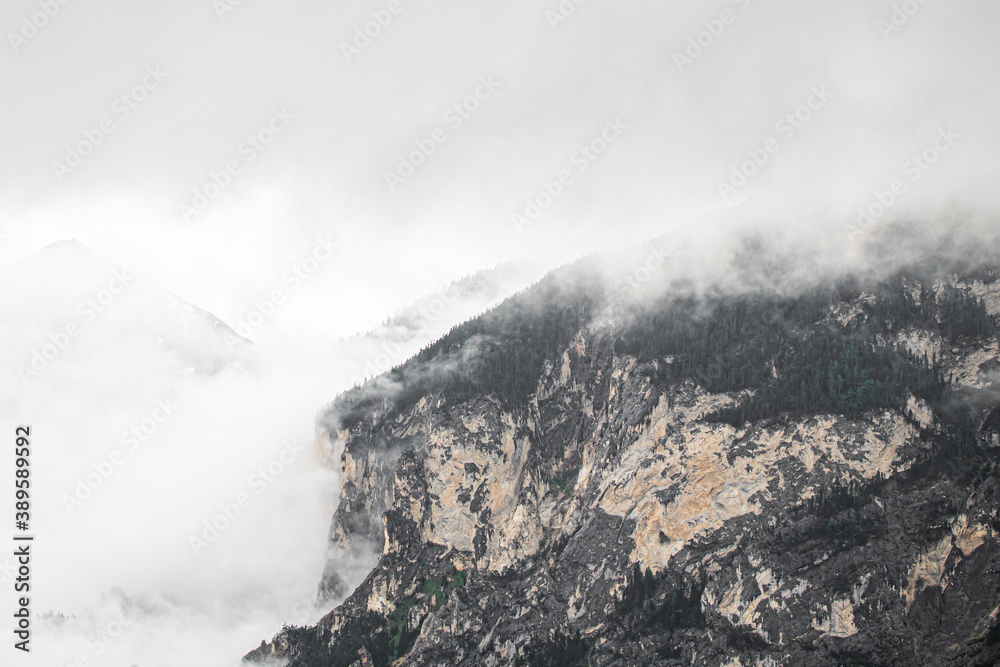 swiss mountains in the clouds, foggy weather in Switzerland