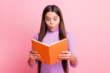 Photo of astonished latin kid girl read textbook wear purple jumper isolated over pastel color background