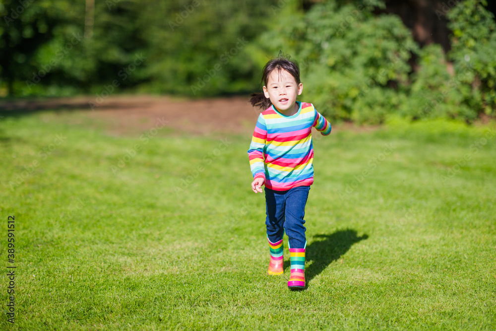 young girl running in the summer garden in the morning young girl running in the summer garden in the morning