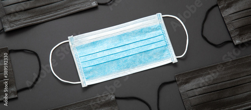 Blue Medical mask, Medical protective mask on black background. Disposable surgical face mask cover. Prevent Coronavirus quarantine, covid 19 lockdown hygiene Healthcare concept. Long web banner