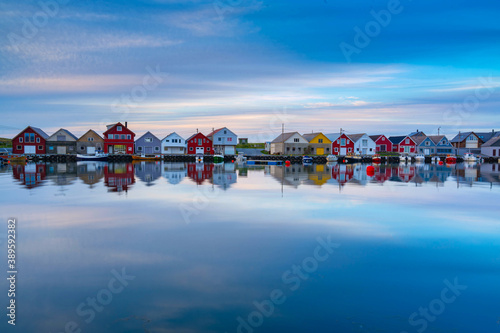 Colorful traditional boathouses reflection in sea. Location: Ferkingstad, Norway