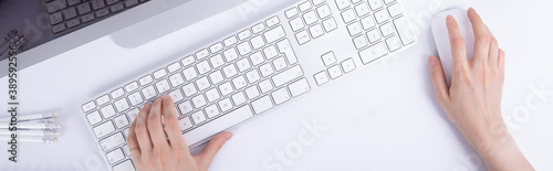 top view of female hands typing on keyboard and using computer mouse, work concept . High quality photo