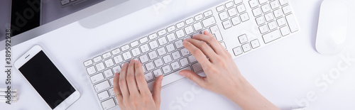 top view of female hands typing on computer keyboard, work concept . High quality photo