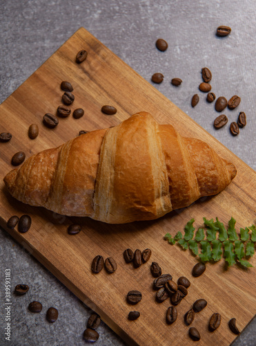croissant with strawberry jam and coffee beans