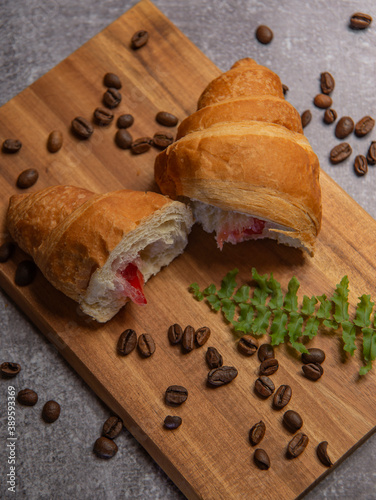 croissant with strawberry jam and coffee beans