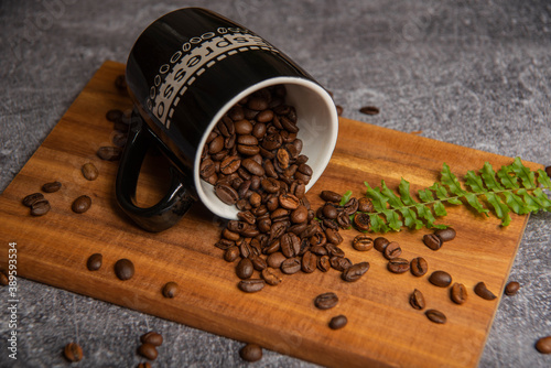 roasted coffee beans and a cup of coffee