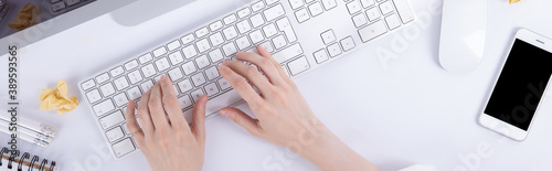 top view of female hands typing on computer keyboard, work concept 