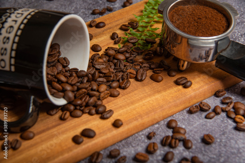roasted coffee beans and a cup of coffee